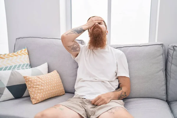 Young Redhead Man Stressed Sitting Sofa Home — Stockfoto
