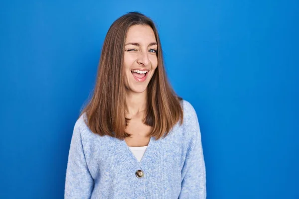 Young Woman Standing Blue Background Winking Looking Camera Sexy Expression — Foto de Stock
