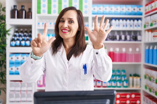 Middle Age Brunette Woman Working Pharmacy Drugstore Showing Pointing Fingers — Stock Photo, Image