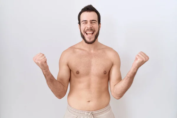 Young Hispanic Man Standing Shirtless White Background Celebrating Surprised Amazed — Stock Photo, Image