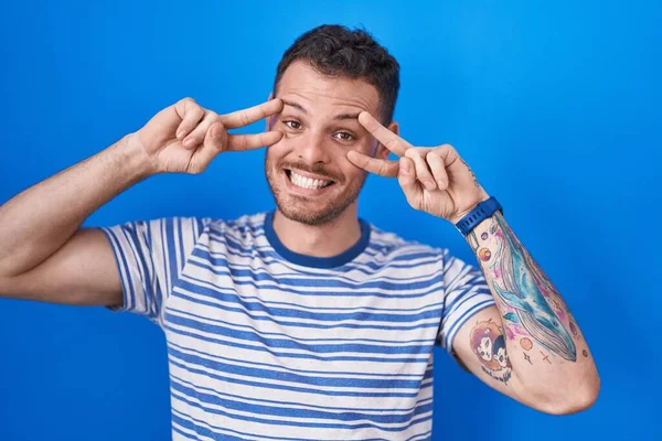 Young Hispanic Man Standing Blue Background Doing Peace Symbol Fingers — Stock Photo, Image