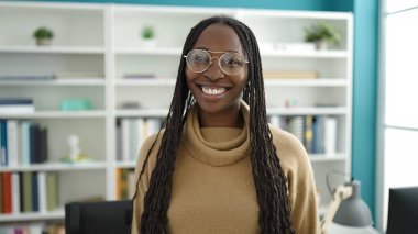African woman smiling confident at library university