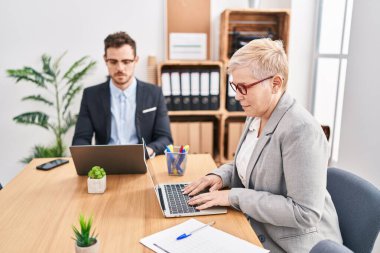 Mother and son business workers using laptop working at office