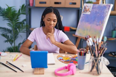 African american woman artist having online draw class at art studio