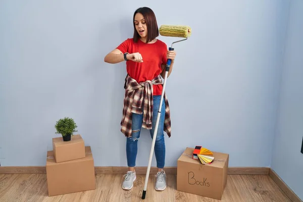 Young Hispanic Woman Painting Home Walls Paint Roller Looking Watch — Stock Photo, Image