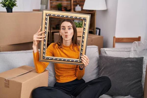 Young Caucasian Woman New Home Holding Empty Frame Making Fish — Stock Photo, Image