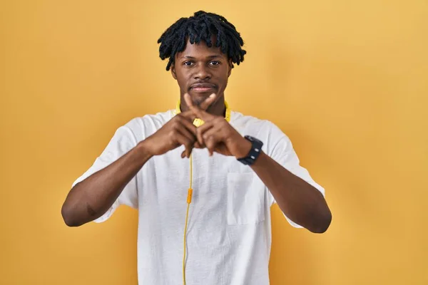 Young African Man Dreadlocks Standing Yellow Background Rejection Expression Crossing — Stock Photo, Image