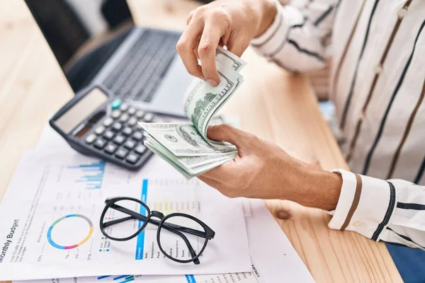 stock image Young hispanic man counting dollars at office