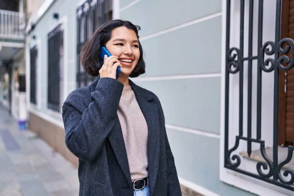 stock image Young woman smiling confident talking on the smartphone at street