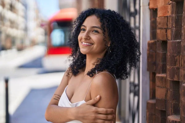 Young Hispanic Woman Looking Side Touching Arm Street — Stok fotoğraf