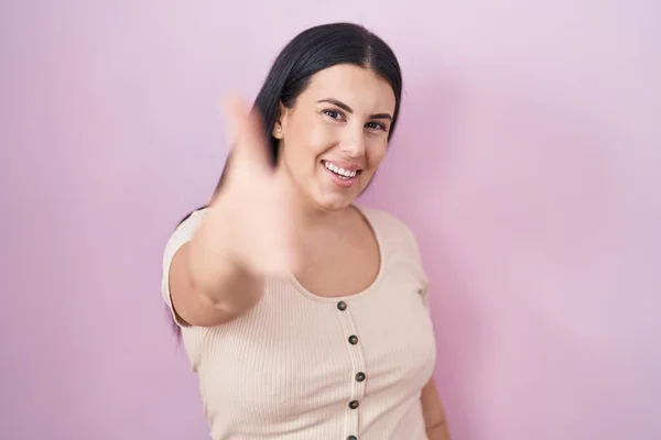 Young Hispanic Woman Standing Pink Background Smiling Friendly Offering Handshake — Zdjęcie stockowe