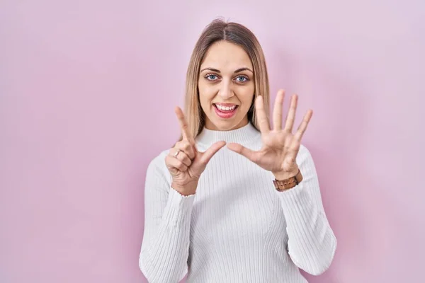 Young Blonde Woman Wearing White Sweater Pink Background Showing Pointing — Stock Photo, Image