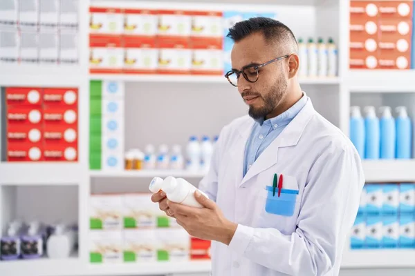 Young Hispanic Man Pharmacist Holding Pills Bottles Pharmacy — 스톡 사진