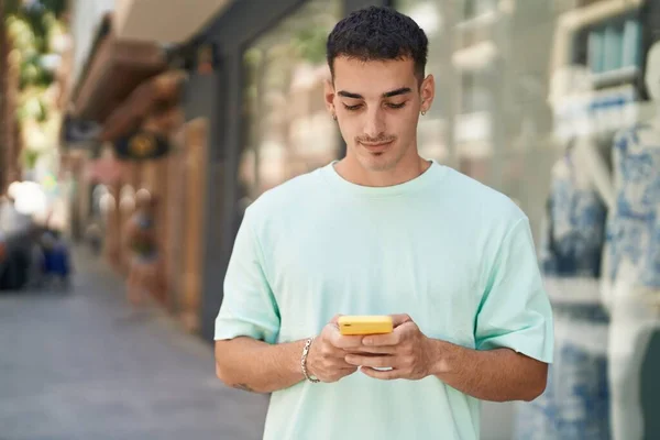 Ung Latinamerikansk Man Använder Smartphone Med Allvarliga Uttryck Gatan — Stockfoto