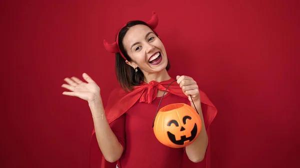 Young Beautiful Hispanic Woman Wearing Devil Costume Holding Halloween Pumpkin — ストック写真
