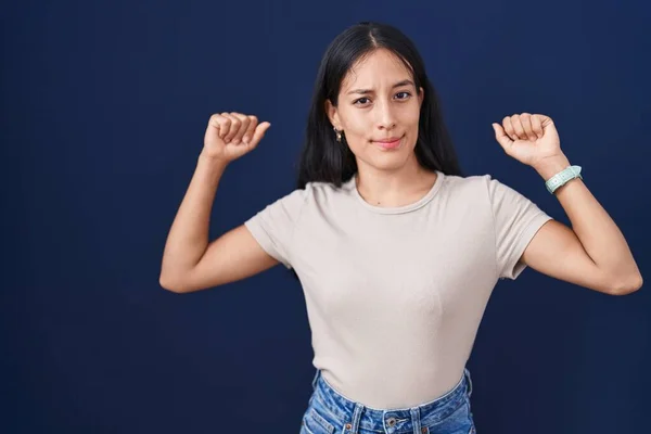 Young Hispanic Woman Standing Blue Background Showing Arms Muscles Smiling — Stock fotografie