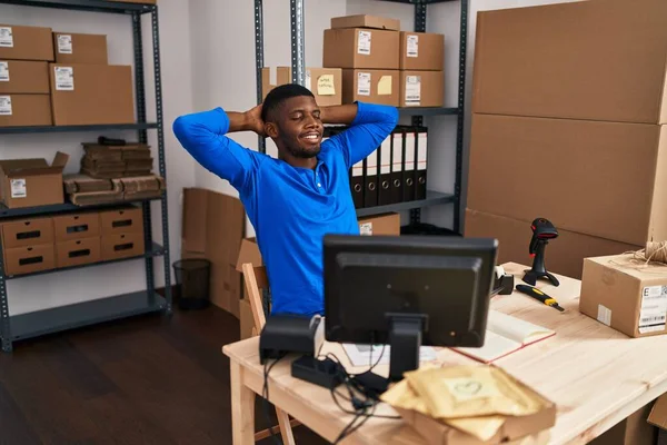 stock image Young african american man ecommerce business worker relaxed with hands on head at office