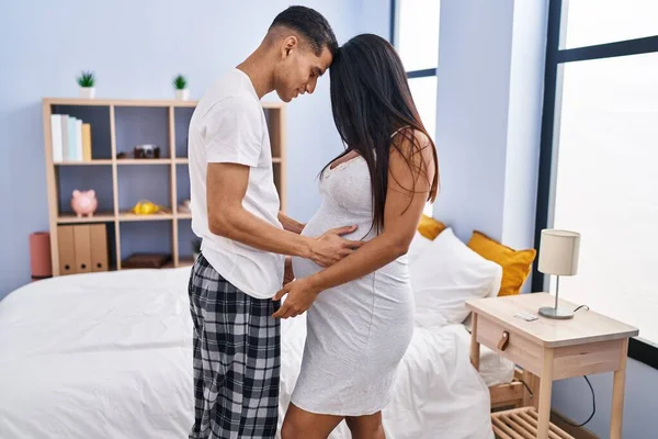 Young Latin Couple Expecting Baby Standing Together Bedroom — Stok fotoğraf