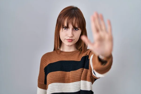 年轻美丽的女人穿着条纹毛衣在孤立的背景上做停止用手掌唱歌 用消极而严肃的手势警告人 — 图库照片