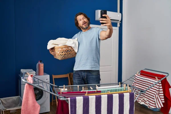 Handsome Middle Age Man Holding Laundry Basket Doing Selfie Picture — Stock Photo, Image