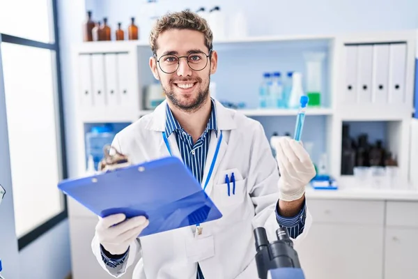 Young Man Scientist Reading Report Holding Test Tube Laboratory — Stock Photo, Image