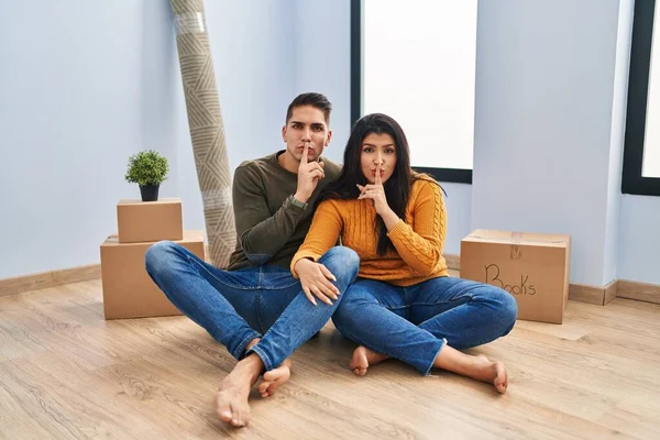 Young Couple Sitting Floor New Home Asking Quiet Finger Lips — Stock Photo, Image