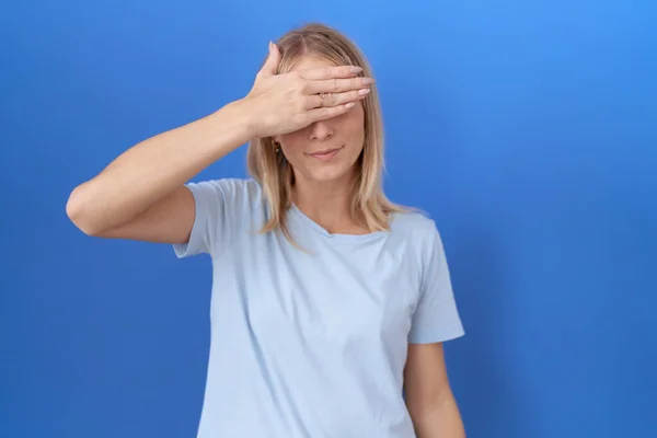 Young Caucasian Woman Wearing Casual Blue Shirt Covering Eyes Hand — Stock Photo, Image