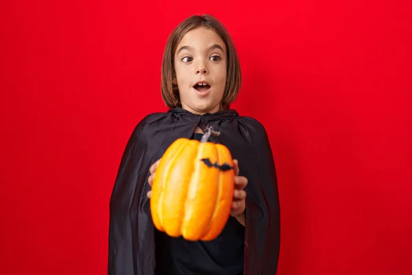 Malý Hispánský Chlapec Kápi Držící Halloweenskou Dýni Překvapený Nápadem Nebo — Stock fotografie