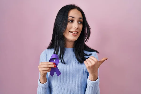 Hispanic Woman Holding Purple Ribbon Awareness Pointing Thumb Side Smiling — Stock Photo, Image