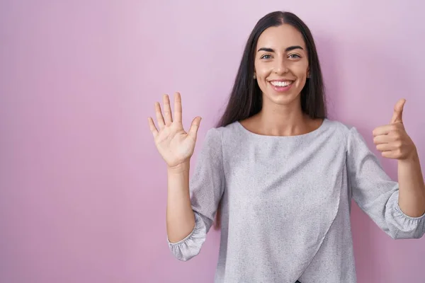 Young Brunette Woman Standing Pink Background Showing Pointing Fingers Number — Stockfoto