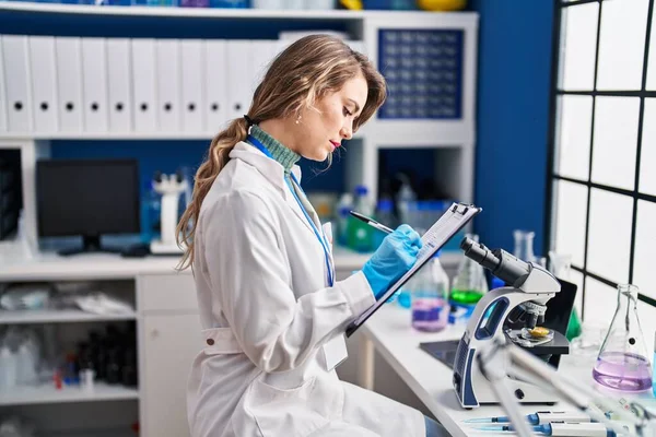 Young Woman Scientist Writing Report Laboratory — Fotografia de Stock