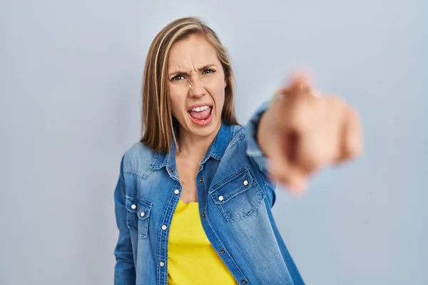Young Blonde Woman Standing Blue Background Pointing Displeased Frustrated Camera — Stockfoto