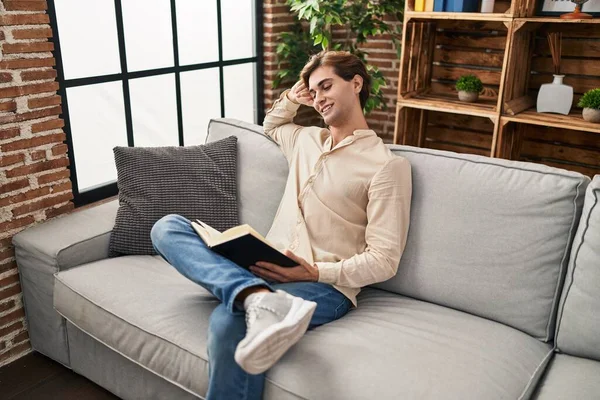 Young Caucasian Man Reading Book Sitting Sofa Home — Foto Stock