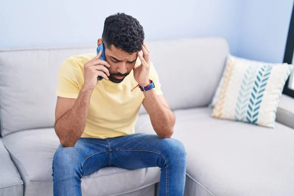 Jovem Árabe Homem Falando Smartphone Com Expressão Preocupada Casa — Fotografia de Stock