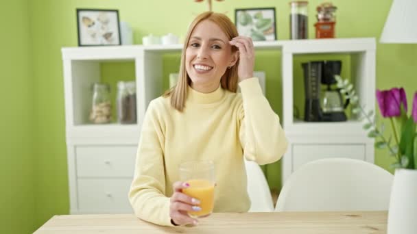 Young Blonde Woman Drinking Orange Juice Speaking Home — Stock Video