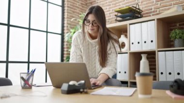 Young beautiful hispanic woman business worker using laptop working at office