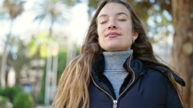 Young caucasian woman smiling confident breathing at park