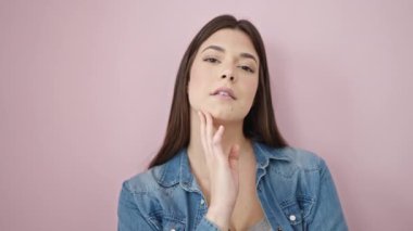 Young beautiful hispanic woman smiling confident standing over isolated pink background
