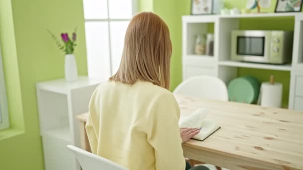 Young Blonde Woman Reading Book Sitting Table Home — Video
