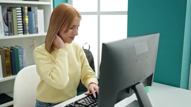Young Blonde Woman Student Using Computer Stressed University Classroom — Stockvideo
