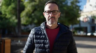 Middle age man doing stop gesture with hand at park