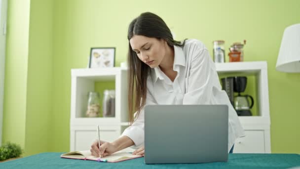 Young Beautiful Hispanic Woman Using Laptop Writing Notebook Dinning Room — Stock Video