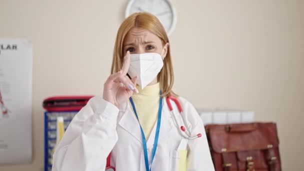 Young Blonde Woman Doctor Saying Finger Wearing Medical Mask Clinic — Stock Video