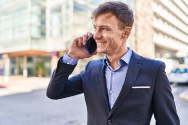 Young man business worker smiling confident talking on smartphone at street