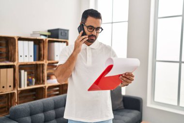 Genç İspanyol psikolog, psikoloji merkezindeki akıllı telefon okuma raporuyla konuşuyor.