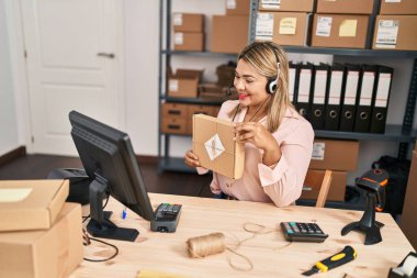 Young hispanic woman ecommerce business worker having video call at office