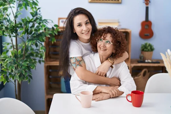 Two Women Mother Daughter Drinking Coffee Hugging Each Other Home — Stockfoto