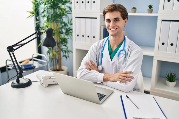 Young Caucasian Man Doctor Smiling Confident Sitting Table Arms Crossed — Stock Photo, Image