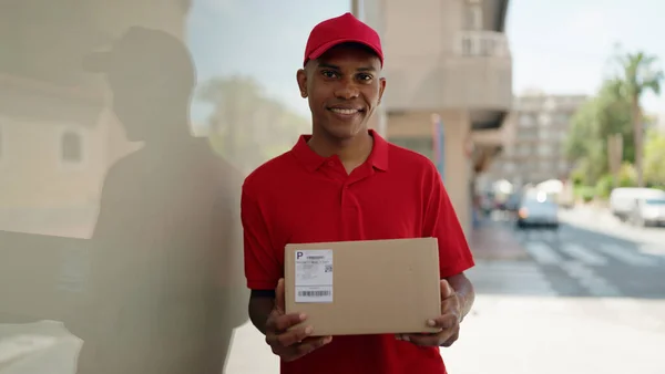 Young Latin Man Delivery Worker Holding Package Street — Stok fotoğraf