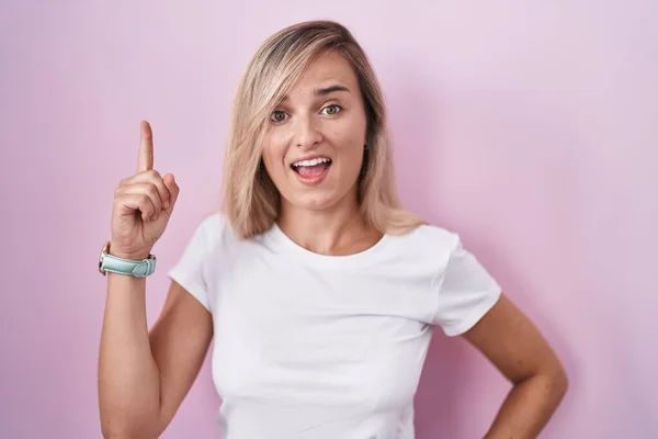 Young Blonde Woman Standing Pink Background Pointing Finger Successful Idea — Stock Photo, Image